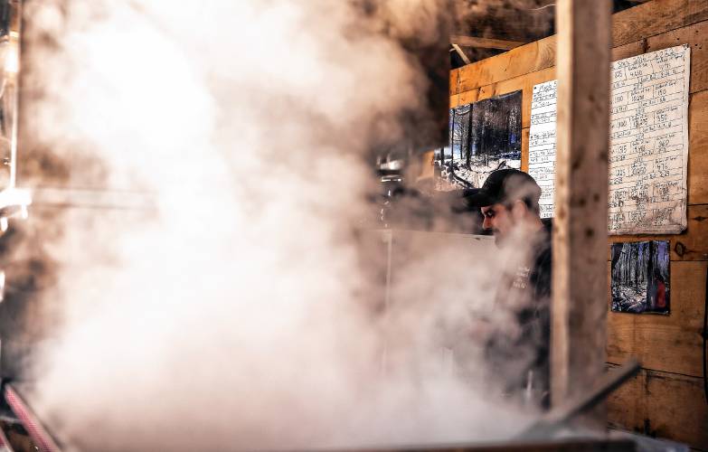Asa Matras of Matras Maple Sugarhouse in Pittsfield checks on the water content of sap as he and family boil for syrup on Monday, March 10, 2025. The sugarhouse will be open this weekend for the New Hampshire Maple Weekend. To learn more, go to their website at https://www.matrasmaple.com/
