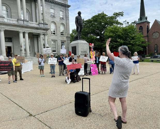 Louise Spencer, a leader of the Kent Street Coalition, rallies a group protesting proposed voting laws, Medicaid cuts, school library policies and more ahead of the state budget vote on Thursday.