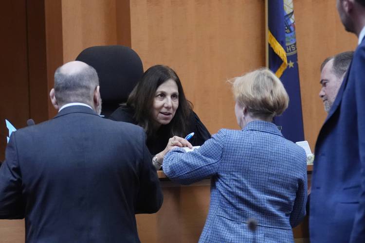 Judge Amy Messer, seated at center, listens to defense and prosecution attorneys during the trial of the Adam Montgomery at Hillsborough County Superior Court, Tuesday, Feb. 20, 2024, in Manchester, N.H. Montgomery is facing second-degree murder and other charges in the death of his daughter, Harmony. (AP Photo/Charles Krupa, Pool)