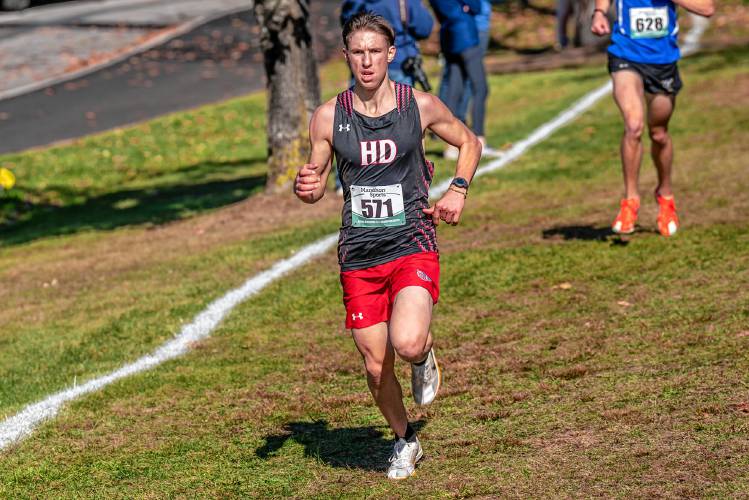 Hillsboro-Deering’s Elijah Bodanza races past an opposing runner in the last half mile of the NHIAA Division III boys’ cross country championship on Saturday at Derryfield Park in Manchester. Bodanza went on the win H-D’s first cross country title in school history.
