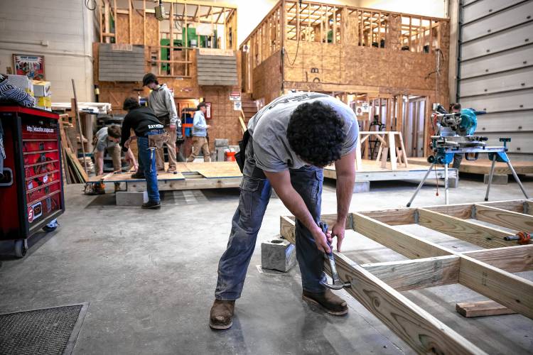 Concord Regional Technical Center student Jeydon Wilson, a Concord High senior, nails a framing project on Thursday.