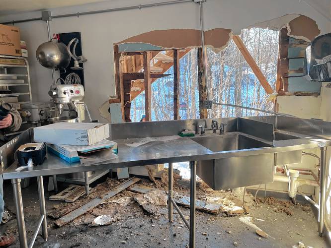 Firefighters knocked down kitchen walls at Sweet Beet Market and Cafe in Bradford to put out the fire.