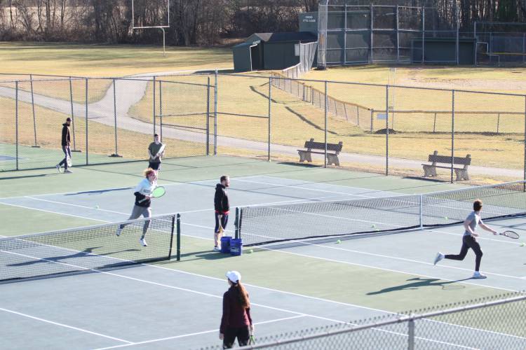 Assistant coach Richie Clar (middle) runs drills with rotating groups of boys on the team, (left to right) junior Bennett Cyr, junior Weston Koerber and senior Bryce Fisher.