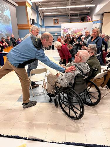 Edward Cherian Jr., the chair of Boscawen’s Zoning Board of Adjustment, thanks Roger Sanborn, who was honored at Town Meeting on March 12 with a standing ovation. 