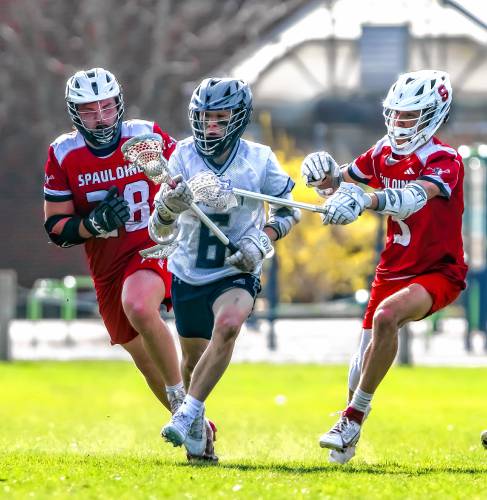 Merrimack Valley midfielder Carter Lankhorst is chased by Spaulding players Seth Cortina (left) and Thomas McGeehan during first half action on Tuesday.