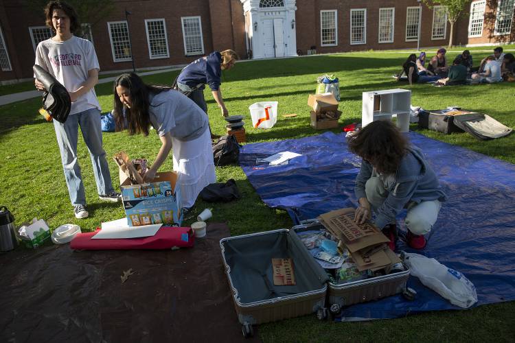 From left, Dartmouth students Brendan Brophy, Rachel Kahng and Sean Wallace pack up their “Brave Space” on Baker Lawn in Hanover on Tuesday. Students set up and break down the space, which includes tarps for visitors to sit and a lending library, every day in order to comply with campus policies. Dartmouth undergraduate students passed a vote of “no confidence” in President Sian Beilock, 1,425 to 1,323, on Wednesday. From left, Dartmouth students Brendan Brophy, Rachel Kahng and Sean Wallace pack up their “Brave Space” on Baker Lawn in Hanover on Tuesday. Students set up and break down the space, which includes tarps for visitors to sit and a lending library, every day in order to comply with campus policies. Dartmouth undergraduate students passed a vote of “no confidence” in President Sian Beilock, 1,425 to 1,323, on Wednesday.