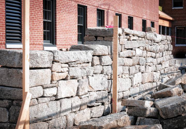 Granite wall being rebuilt. Granite wall being rebuilt.