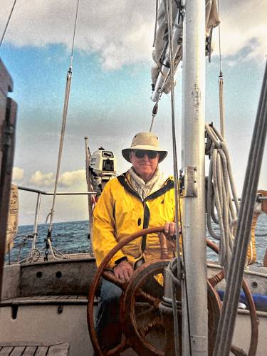 Rodney Tenney steers his sail boat. 