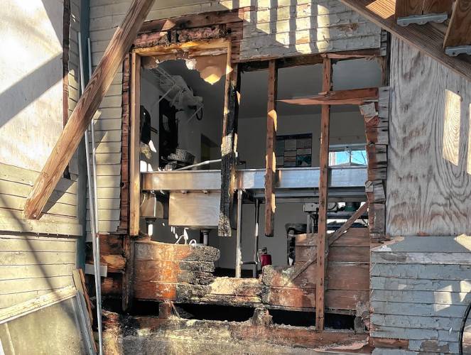 Firefighters knocked down kitchen walls at Sweet Beet Market and Cafe in Bradford on Tuesday to put out the fire.