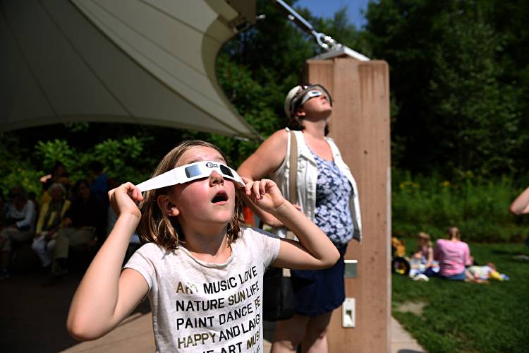 Ella Dahlstrom,8, of Hartford, Vt., and Becca Girrell, of Lebanon, N.H. view the solar eclispe at the Montshire Museum of Science, in Norwich, Vt., on Aug. 21, 2017. About 1,300 people came to the museum to see the eclispe. (Valley News - Jennifer Hauck) Copyright Valley News. May not be reprinted or used online without permission. Send requests to permission@vnews.com. Ella Dahlstrom,8, of Hartford, Vt., and Becca Girrell, of Lebanon, N.H. view the solar eclispe at the Montshire Museum of Science, in Norwich, Vt., on Aug. 21, 2017. About 1,300 people came to the museum to see the eclispe. (Valley News - Jennifer Hauck) Copyright Valley News. May not be reprinted or used online without permission. Send requests to permission@vnews.com.