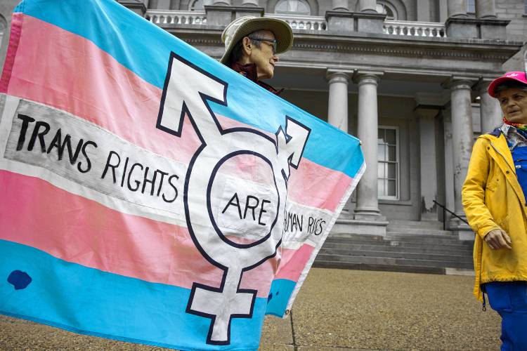 Nancy Brennan (left) holds up a Trans Rights sign with her daughter, Molly Brennan, in front of the State House as the senate begins to vote on several trans bills on Thursday, May 16, 2024.