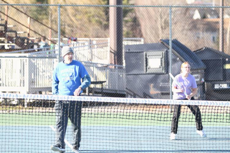 Concord girls’ tennis coach Greg Malette instructs freshman Bryn Washburn during practice in preparation for the season.