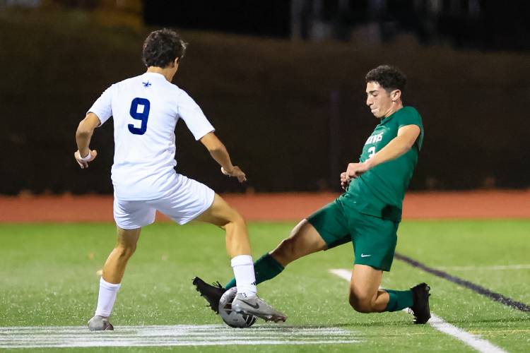 Hopkinton senior defender Noah Aframe (3) slide tackles St. Thomas junior midfielder Aaron Page (9) during Hopkinton’s Division III semifinal victory on Nov. 6. Aframe was named to the D-III All-State First Team.