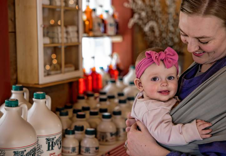 Lindsay Matras of Matras Maple Sugarhouse in Pittsfield holds her six-month-old daughter, Caroline as the family boils for syrup on Monday, March 10, 2025. The sugarhouse will be open this weekend for the New Hampshire Maple Weekend. To learn more, go to their website at https://www.matrasmaple.com/