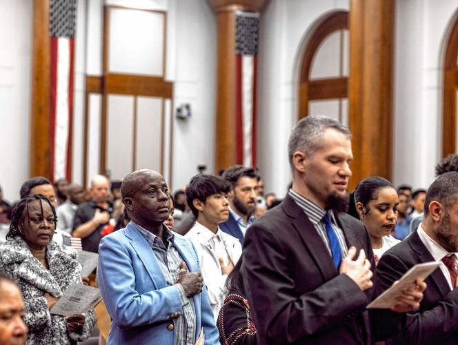 Kayitani Ndutiye gets sworn in as a United States citizen with 70 others last Friday in a ceremony at the Federal Court in Concord, days before the New Hampshire primary.