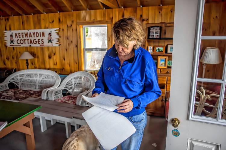 Laura Prichard in the boathouse on the shore of the Keewaydin area of Lake Winnipasaukee. The former lake community dock was destroyed in a boat accident last year.