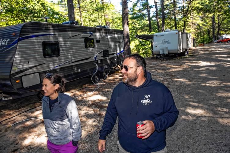 Suncook River Campâs new owners Joe and Kim Caprio walk along the path where RVs park along the river in Allenstown.