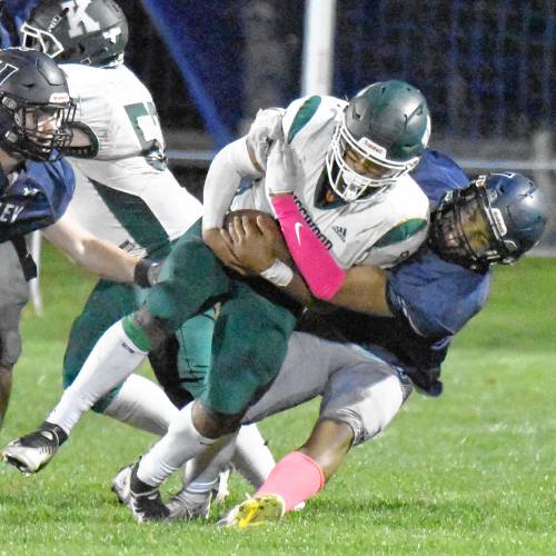 Merrimack Valley’s Mahamed Shegow tackles Kingswood’s Tyrese Ryder (2) during a game in Penacook on Friday night. Ryder ran for 132 yards in Kingswood’s 20-17 victory.