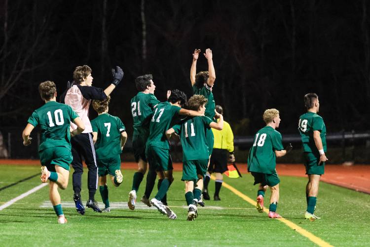 The Hopkinton Hawks celebrate Nolan Linstad’s late game-winning goal in front of a large crowd of supporters. Linstad’s goal lifted the No. 1 Hawks to a 1-0 semifinal win against No. 4 St. Thomas to advance to Saturday’s Division III championship game.