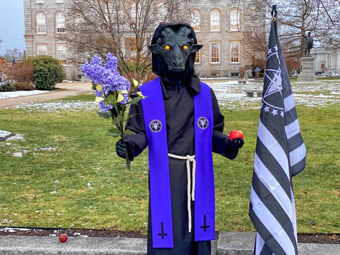 The Satanic Temple's holiday display, including a Baphomet statue and 7 tenets of the religion, was placed Saturday in the city plaza in front of the NH State House.