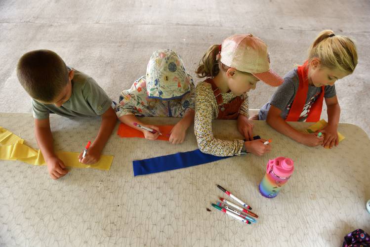 Campers Greyson Noll, 6, of Reading, Vt., Ansel Davis, 5, of Reading, Nina Davis, 9, of Reading, and Hazel Tolosa, 6, of New London. N.H., decorate flags on a rainy morning in Brownsville, Vt., last July. Campers Greyson Noll, 6, of Reading, Vt., Ansel Davis, 5, of Reading, Nina Davis, 9, of Reading, and Hazel Tolosa, 6, of New London. N.H., decorate flags on a rainy morning in Brownsville, Vt., last July.