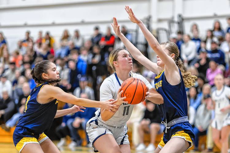 Merrimack Valley's Kayla Smith (11) goes to the basket while being tightly guarded by Bow's Gabby Tarsa (left) and Reis Domini (right) during the Capital Classic girls' basketball championship game at Pembroke Academy on Monday, Dec. 30, 2024. Smith scored a team-high 15 points, but Bow claimed the Capital Classic title with a 43-41 victory.