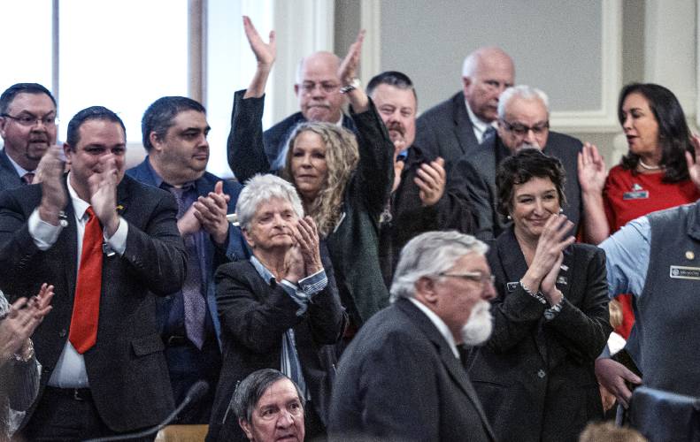 House members applaud as Sherman Packard walks up after winning re-election as the House Speaker on Wednesday, December 7, 2022.