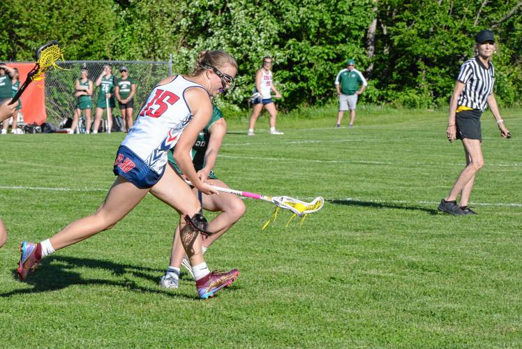 John Stark/Hillsboro-Deering midfielder Addie DeCew (15) scoops up a loose ball during a Division II girls' lacrosse first round game in Weare on Tuesday. JSHD defeated Kingswood, 12-5, to advance to the quarterfinals. JOSHUA SPAULDING / Salmon Press