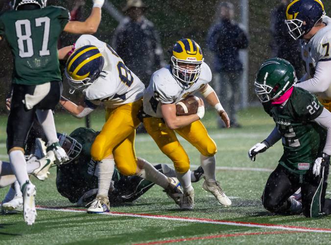 Bow running back Caleb Schumacher (2) cuts through a hole in the line made by teammates Eli Ayers (88) and Hunter Hutchinson (74) in a football game against Pembroke Academy at Derryfield Park in Manchester last season.Schumacher and the entire offense is back for the 2024 season.