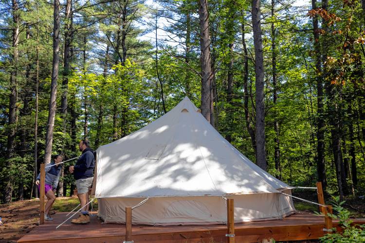 Suncook River Campâs new owners Joe and Kim Caprio in front of the two platform tents that are available to rent on the property that borders the river in Allenstown.