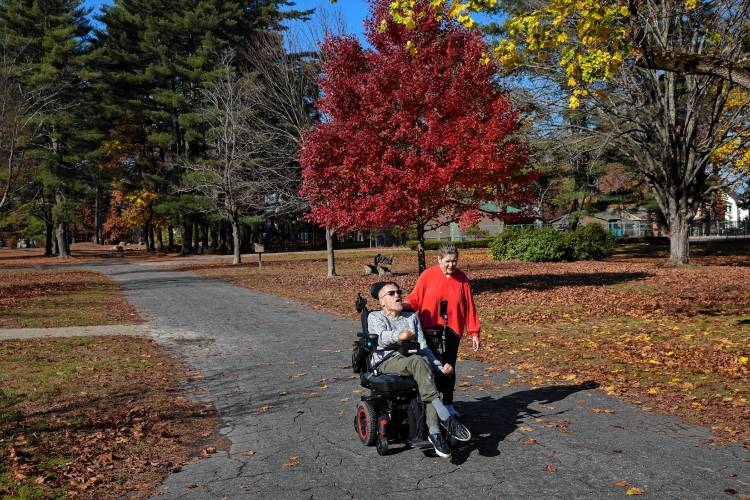 Concord couple James Piet and Patricia Vincent-Piet enjoy the accessibility of Rollins Park, which is close to their South Concord home. However, he is getting used to his new custom chair, which can only be used on paved surfaces.