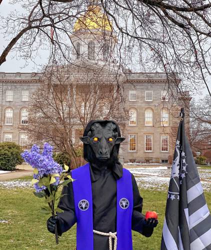 The Satanic Temple's holiday display, including a Baphomet statue and 7 tenets of the religion, was placed Saturday in the city plaza in front of the NH State House.