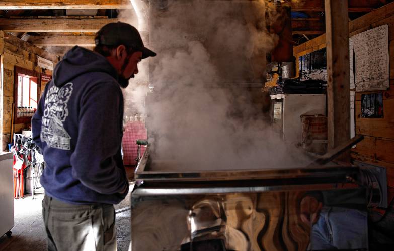 Asa Matras of Matras Maple Sugarhouse in Pittsfield checks on the water content of sap as he and family boil for syrup on Monday, March 10, 2025. The sugarhouse will be open this weekend for the New Hampshire Maple Weekend. To learn more, go to their website at https://www.matrasmaple.com/