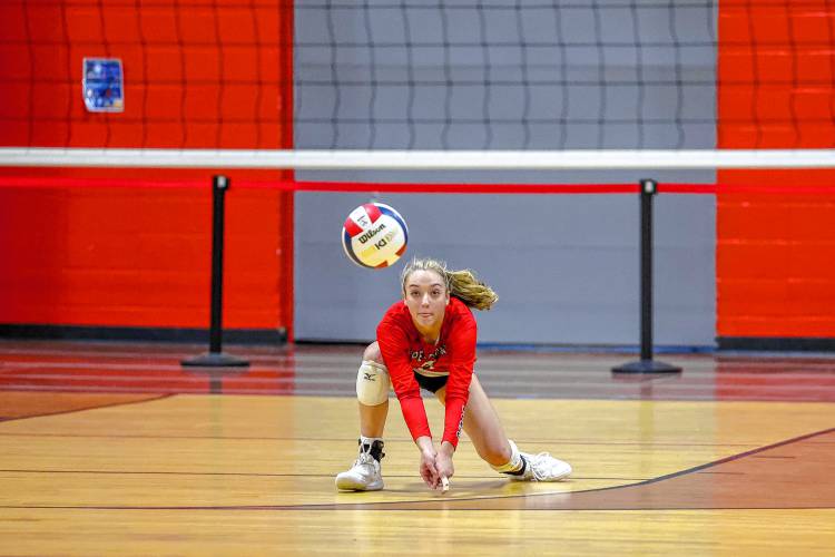 Coe-Brown junior Haile Comeau prepares for a dig in the Division II volleyball championship against Oyster River on Saturday.