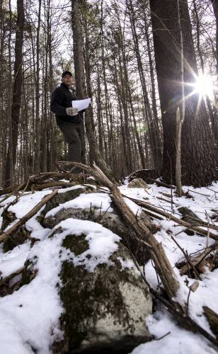 State geologist Rick Chormann and driving force behind the New Hampshire Stone Wall Project looks over a LIDAR readout on the stone wall in Concord on Jan. 15, 2019.