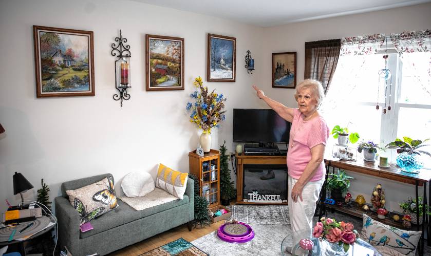Bette Hill shows her artwork on April 3 in her one bedroom apartment at Penacook Landing on Canal Street.