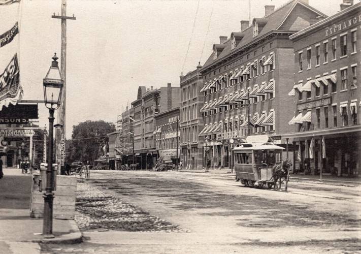 A very early view of Main Street in Concord depicting an early gas lantern. Gas lanterns were used prior to the invention of the electric light to keep our Main Street illuminated for evening shoppers. A very early view of Main Street in Concord depicting an early gas lantern. Gas lanterns were used prior to the invention of the electric light to keep our Main Street illuminated for evening shoppers.