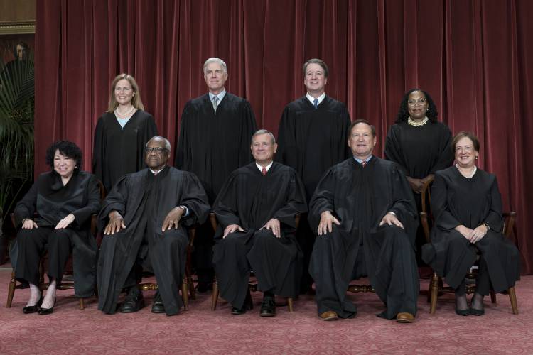 Members of the Supreme Court sit for a new group portrait following the addition of Associate Justice Ketanji Brown Jackson at the Supreme Court building in Washington in October 2022.