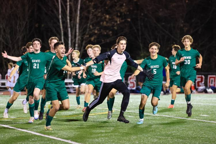 Junior goalkeeper, Hunter Eckner-Naylor (pink), celebrates Hopkinton's 1-0 win over Saint Thomas next to the goalscorer, Nolan Linstad (left).