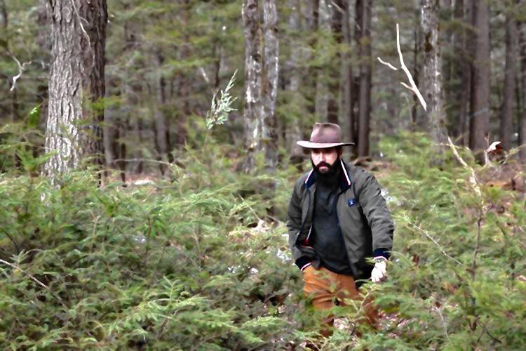 Aleksander Petakov, filmmaker and adventurer, walks through his property toward his shooting range Friday morning in the Monadnock Region. Petakov often explores the wilderness and unknown in his work, searching for ruins, cryptid sightings, UFOs and more