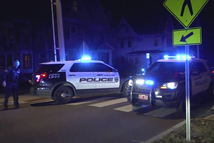 In this still frame from video provided by WCAX-TV Burlington, Vt. Police vehicles rest near a scene Saturday, Nov. 25, 2023 where three men of Palestinian descent were shot and injured, in Burlington, Vt. Burlington Police Department arrested Jason J. Eaton, suspected in the shooting of three young men, who were attending a Thanksgiving holiday gathering near the University of Vermont campus Saturday evening. (WCAX-TV via AP)
