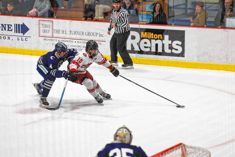 Dawson Fancher tries to control the puck for Concord in the Division I quarterfinal against Exeter. The senior captain totaled 12 goals and 18 assists on the season.