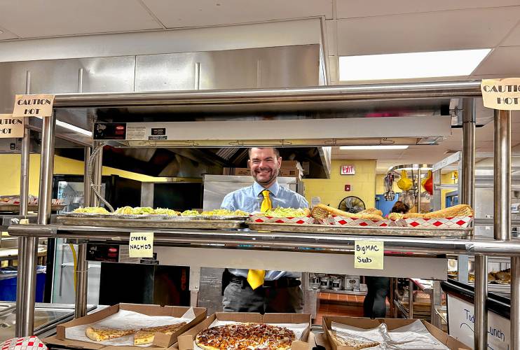 Incoming Bow High School principal Matt Fisk serves students lunch last week.