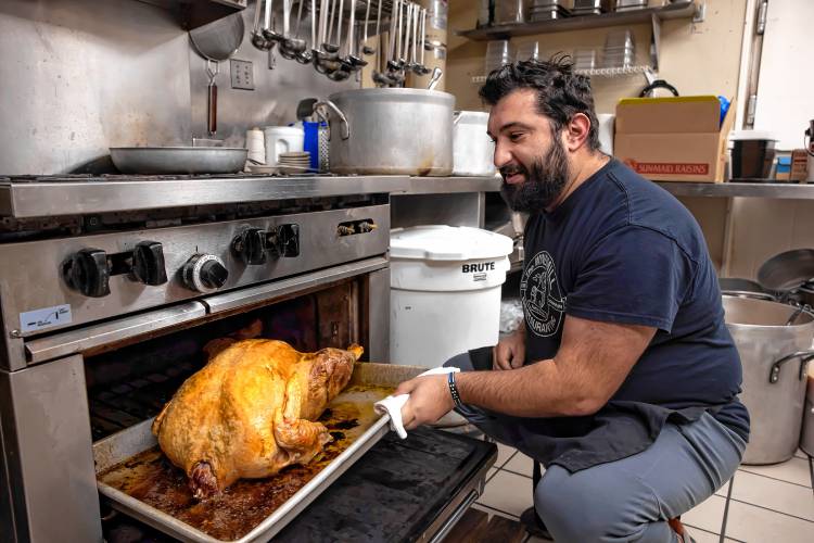 Owner Kosmas Smirnioudis checks on the last turkey he will be cooking for the Windmill Restaurant Thanksgiving on Tuesday morning.