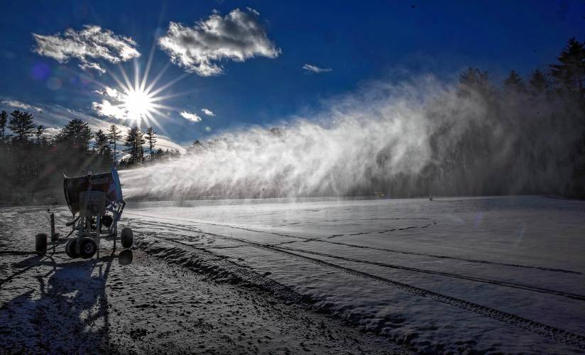 The rented snowmaking fan makes snow on the Beaver Meadow driving range during a test run on Friday, December 6, 2024. 