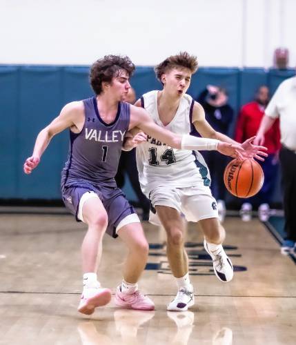 Pembroke Academy guard Jackson Tanguay (14) gets fouled by Merrimack Valley guard Thatcher Stearn during the first half of Monday’s game.