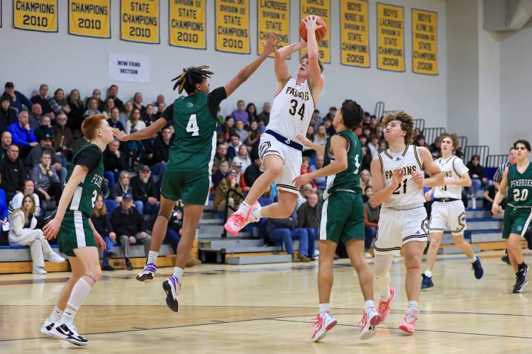 Bow’s Jake Reardon (34) goes up for a shot over Pembroke’s Javien Sinclair on Friday night. Reardon scored 27 points as the Falcons upset Pembroke, 61-54.