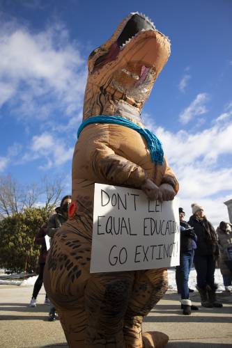 One of the protesters in the crowd at the State House gathered on Tuesday to advocate against state cuts to special education funding.