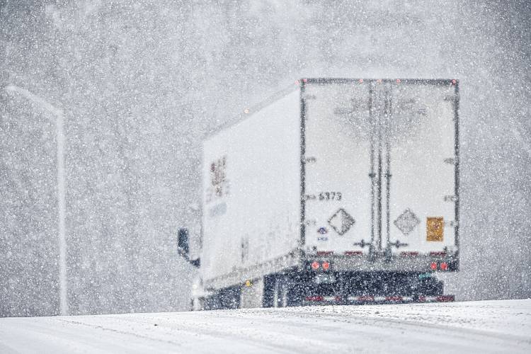 A tractor trailer gets on to the entrance ramp of I-93 southbound at exit 16 during the snow storm in Concord on Tuesday, Jan. 16, 2024.