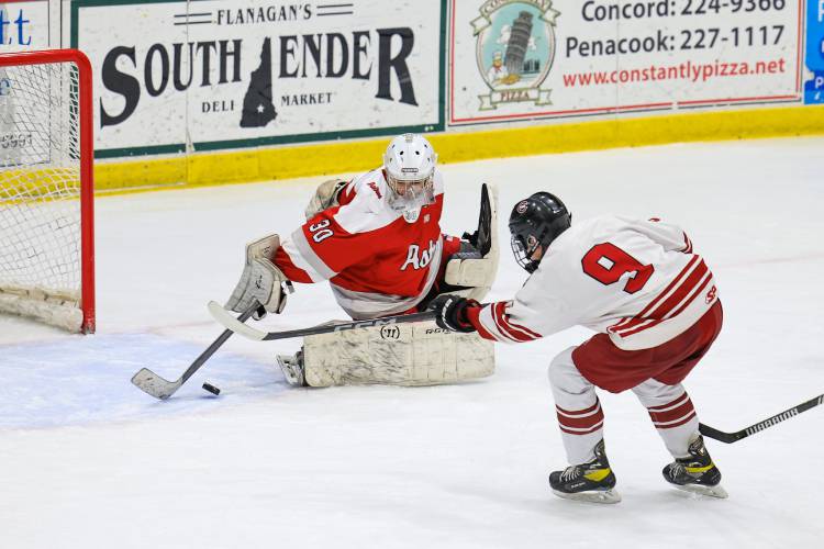 Concord’s Carter Doherty (9) fires the puck beneath the stick of Pinkerton’s goalie to score one of his two goals in the Crimson Tide's 7-1 victory at Everett Arena on Saturday. Doherty also had an assist. 